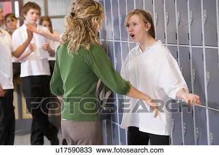 Stock Image - Female teacher reprimanding a female student. Fotosearch