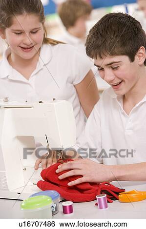 Male and female student using sewing machine View Large Photo Image Stock Photograph - Male and female student using sewing machine. Fotosearch