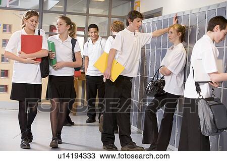 Stock Image - Secondary school students in a school hallway. Fotosearch
