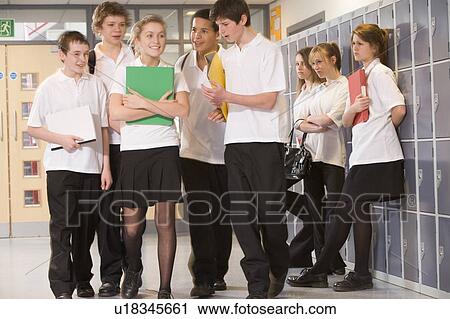 Stock Image - Secondary school students in a school hallway. Fotosearch