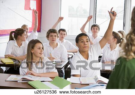 Stock Photograph - Secondary school students in a classroom answering questions. Fotosearch