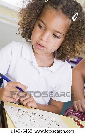 Stock Photo - Student in class learning numbers (selective focus). Fotosearch