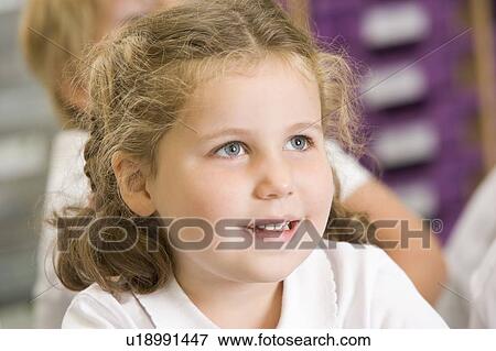 Stock Photo - Student in class sitting on floor (selective focus). Fotosearch