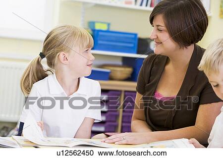 Student in class with teacher reading View Large Photo Image Stock Image - Student in class with teacher reading. Fotosearch