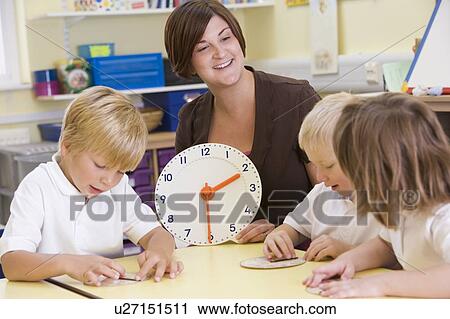 Students in class learning how to tell time (selective focus) View Large Photo Image Stock Image - Students in class learning how to tell time (selective focus). Fotosearch
