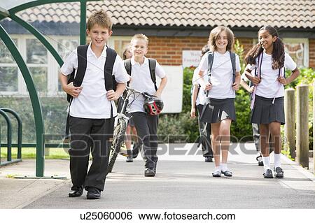 Stock Photograph - Students leaving school one with a bicycle. Fotosearch