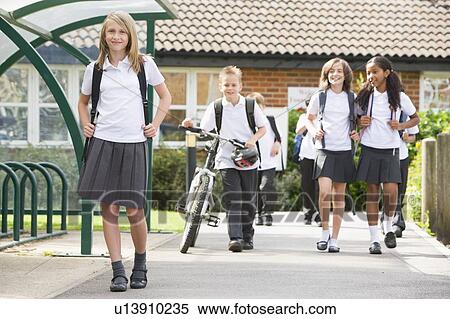 Students leaving school one with a bicycle View Large Photo Image Stock Photography - Students leaving school one with a bicycle. Fotosearch