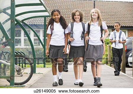 Stock Photography - Three students leaving school with other students in background. Fotosearch