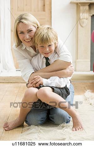Woman in front hallway hugging young boy and smiling View Large Photo Image Stock Photography - Woman in front hallway hugging young boy and smiling. Fotosearch