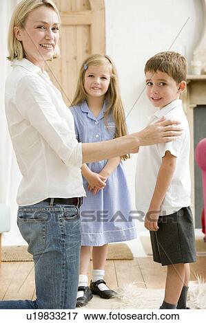 Woman in front hallway with two young children smiling View Large Photo Image Stock Photo - Woman in front hallway with two young children smiling. Fotosearch