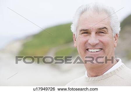 Man at the beach smiling View Large Photo Image Stock Photograph - Man at the beach smiling. Fotosearch