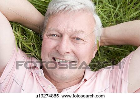 Man lying in grass smiling View Large Photo Image Stock Photography - Man lying in grass smiling. Fotosearch