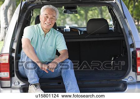Man sitting in back of van smiling View Large Photo Image Picture - Man sitting in back of van smiling. Fotosearch