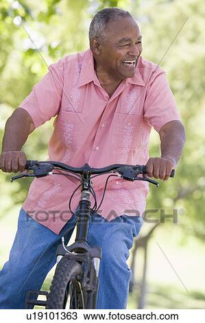 Senior man on a bicycle View Large Photo Image Stock Image - Senior man on a bicycle. Fotosearch