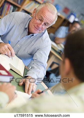 Two men in library with notepads talking (selective focus) View Large Photo Image Stock Photography - Two men in library with notepads talking (selective focus). Fotosearch
