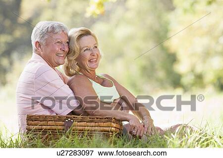 Couple at a picnic smiling View Large Photo Image Stock Photo - Couple at a picnic smiling. Fotosearch