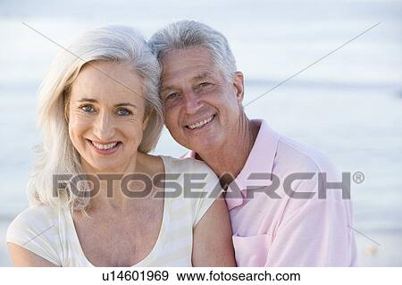 Couple at the beach smiling View Large Photo Image Stock Photo - Couple at the beach smiling. Fotosearch