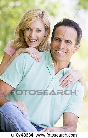Couple outdoors smiling View Large Photo Image Picture - Couple outdoors smiling. Fotosearch