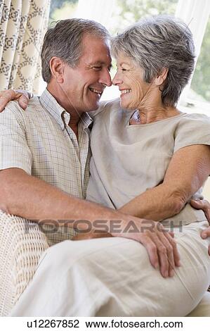 Couple relaxing in living room smiling View Large Photo Image Stock Image - Couple relaxing in living room smiling. Fotosearch