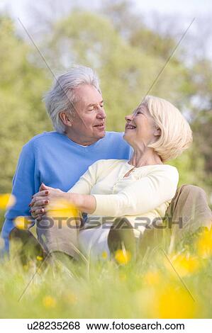 Stock Photo - Couple relaxing outdoors smiling. Fotosearch