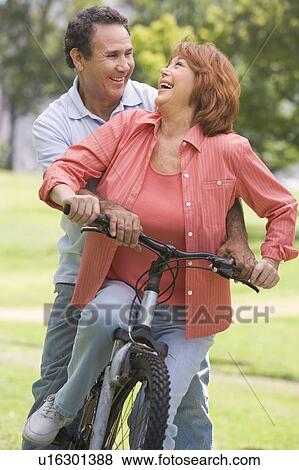Mature couple bike riding. View Large Photo Image Stock Photo - Mature couple bike riding.. Fotosearch