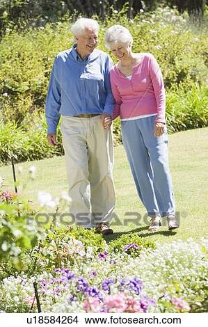 Picture - Senior couple in a flower garden. Fotosearch