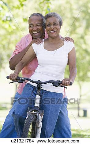 Picture - Senior couple on a bicycle. Fotosearch