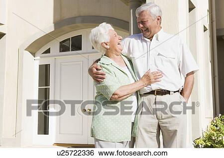 Senior couple standing outside their home View Large Photo Image Stock Photograph - Senior couple standing outside their home. Fotosearch