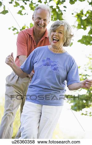 Senior couple walking in park together View Large Photo Image Stock Photo - Senior couple walking in park together. Fotosearch