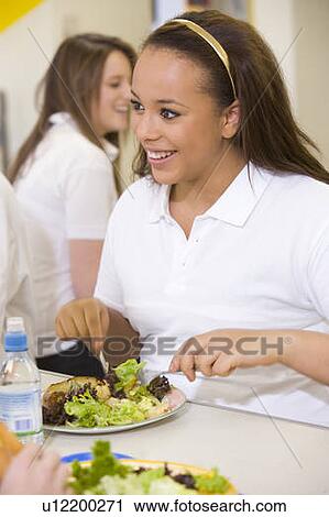 Student having lunch in dining hall View Large Photo Image Stock Image - Student having lunch in dining hall. Fotosearch