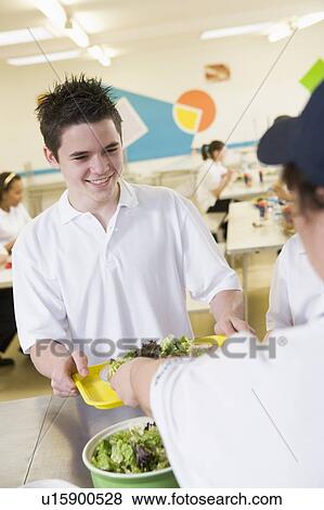 Student having lunch in dining hall View Large Photo Image Stock Photo - Student having lunch in dining hall. Fotosearch