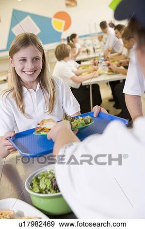 Student having lunch in dining hall View Large Photo Image Stock Photo - Student having lunch in dining hall. Fotosearch