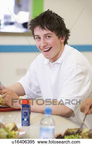 Stock Photography - Student having lunch in dining hall. Fotosearch