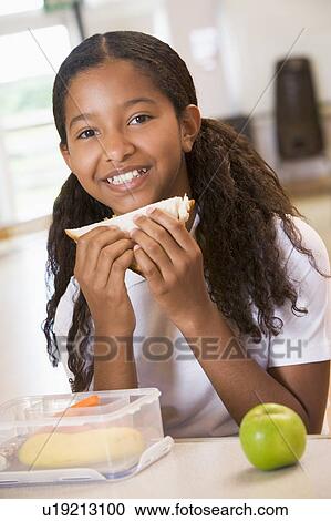Student in cafeteria eating lunch (selective focus) View Large Photo Image Stock Image - Student in cafeteria eating lunch (selective focus). Fotosearch