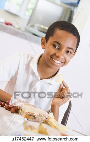 Student in cafeteria eating lunch (selective focus) View Large Photo Image Stock Photo - Student in cafeteria eating lunch (selective focus). Fotosearch