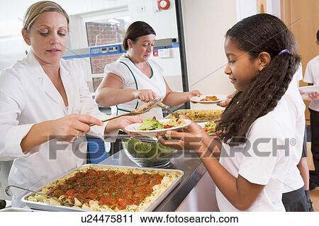 Students in cafeteria line being served lunch View Large Photo Image Stock Image - Students in cafeteria line being served lunch. Fotosearch