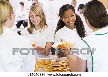Stock Photograph - Students in cafeteria line being served by lunch ladies. Fotosearch