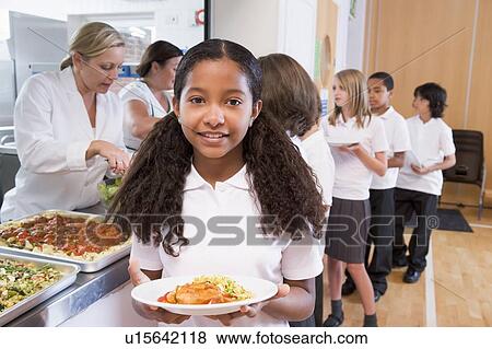 Students in cafeteria line with one holding up her healthy meal looking at camera (depth of field) View Large Photo Image Stock Photo - Students in cafeteria line with one holding up her healthy meal looking at camera (depth of field). Fotosearch