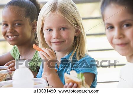 Students outdoors eating lunch (selective focus) View Large Photo Image Stock Image - Students outdoors eating lunch (selective focus). Fotosearch