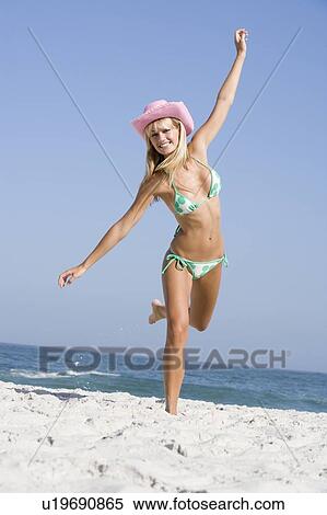 Woman in a two piece bathing suit posing on a beach View Large Photo Image Stock Photography - Woman in a two piece bathing suit posing on a beach. Fotosearch