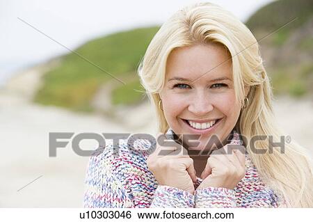 Woman standing at beach smiling View Large Photo Image Stock Photograph - Woman standing at beach smiling. Fotosearch