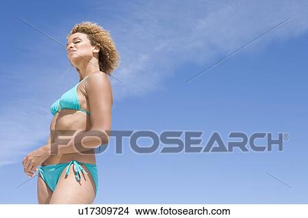 Picture - Young woman in a two piece bathing suit. Fotosearch
