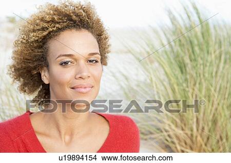Young woman posing on a sand hill View Large Photo Image Picture - Young woman posing on a sand hill. Fotosearch