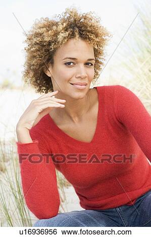 Stock Photograph - Young woman posing on a sand hill. Fotosearch