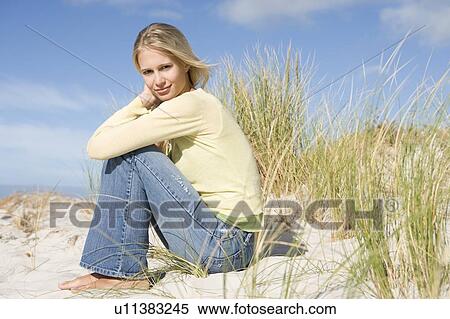 Young woman posing on a sand hill View Large Photo Image Stock Photography - Young woman posing on a sand hill. Fotosearch