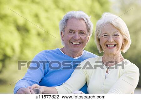 Stock Image - Couple outdoors smiling. Fotosearch
