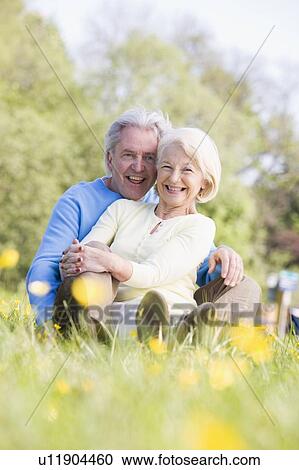 Couple relaxing outdoors smiling View Large Photo Image Stock Image - Couple relaxing outdoors smiling. Fotosearch