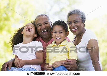 Stock Photo - Grandparents laughing with grandchildren.. Fotosearch