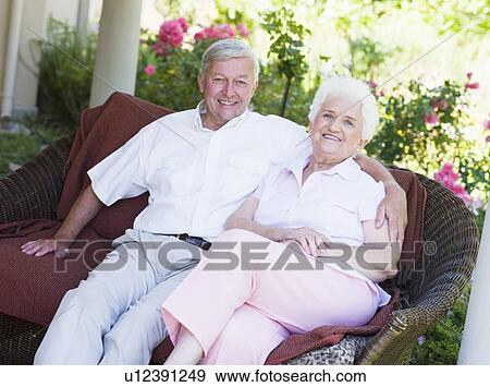 Stock Photo - Senior couple sitting outdoors. Fotosearch