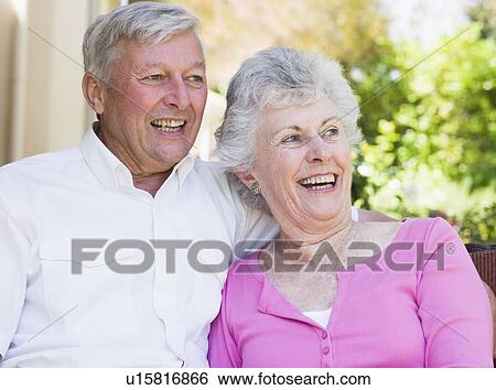 Stock Photograph - Senior couple sitting outdoors. Fotosearch
